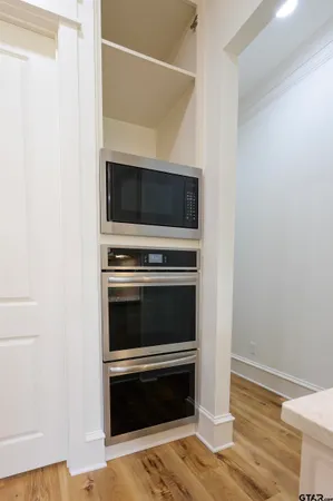 a view of a closet with wooden floor