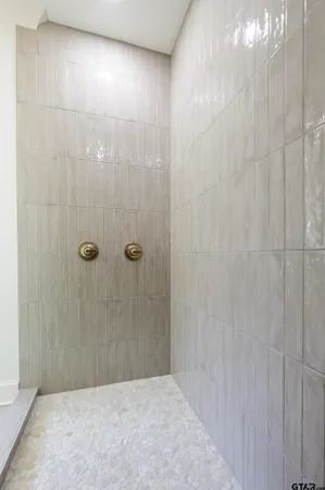 a bathroom with a bathtub and shower
