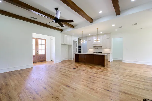 a kitchen with granite countertop a stove a sink and a refrigerator