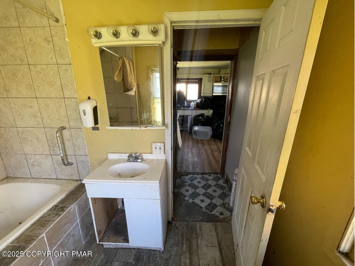 1900 Greenfield Road Jermyn, PA 18433 - Photo 60 of 86 a bathroom with a sink and mirror with bathtub