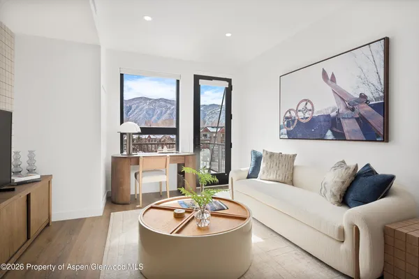a living room with furniture and a painting