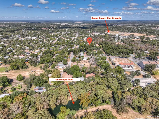 an aerial view of a house with a yard