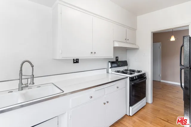 a kitchen with stainless steel appliances granite countertop a sink and a stove