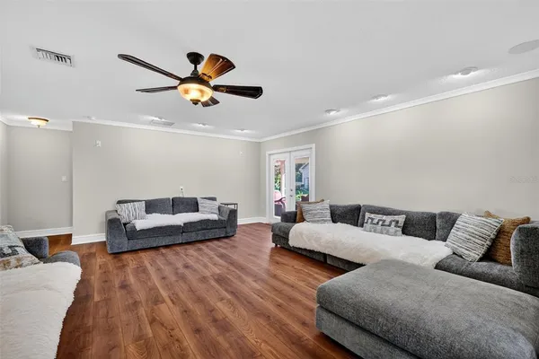 a spacious bedroom with a bed and ceiling fan