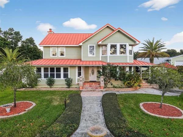a front view of house with yard and green space