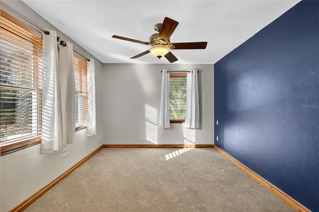 a view of a patio with table and chairs potted plants and a palm tree
