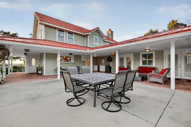 a view of a house with a yard and sitting area