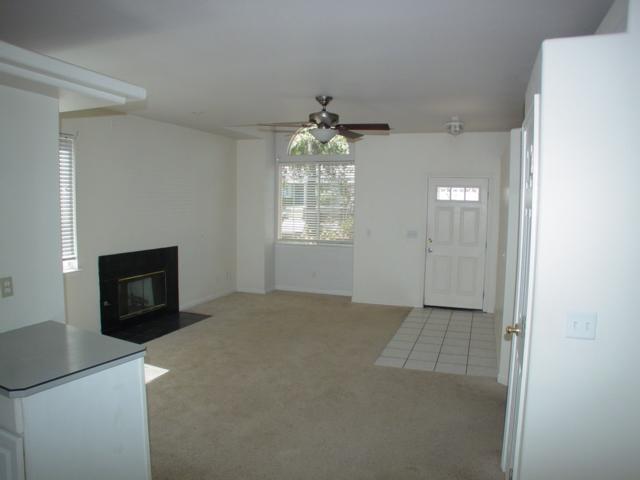 3345 Lawrence Road Redding, CA 96002 - Photo 2 of 5 an empty room with windows and fireplace
