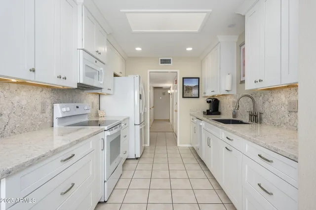 a kitchen with stainless steel appliances granite countertop a sink and cabinets