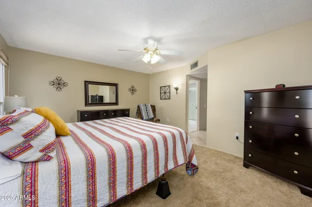 a bedroom with a bed and a dresser