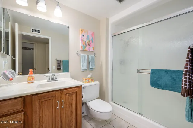 a bathroom with a sink vanity mirror and toilet
