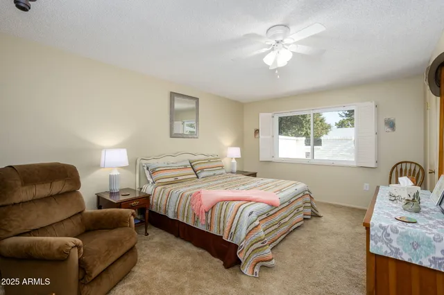 a bedroom with bed couch and window