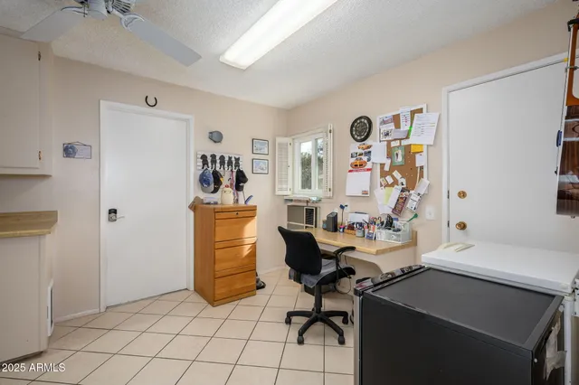 a view of a workspace with furniture and a window