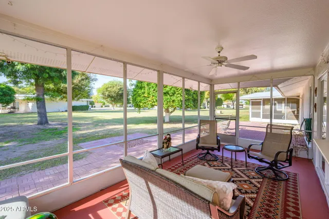a living room with furniture and a floor to ceiling window