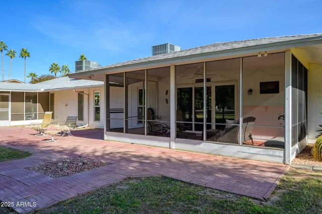 a view of a house with backyard porch and sitting area