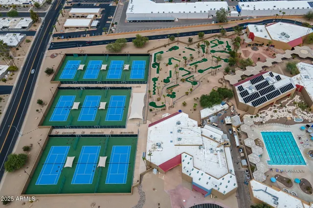 an aerial view of a residential apartment building with a yard