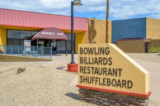 a large room with gym equipment and wooden floor