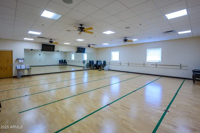 a view of lake with boats and trees in the background