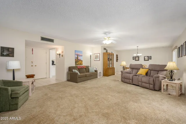 a living room with furniture and a chandelier