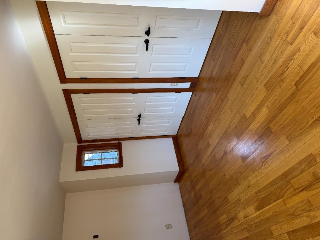 4 Rock Pond Road West Tisbury, MA 02568 - Photo 12 of 37 an empty room with wooden floor and windows