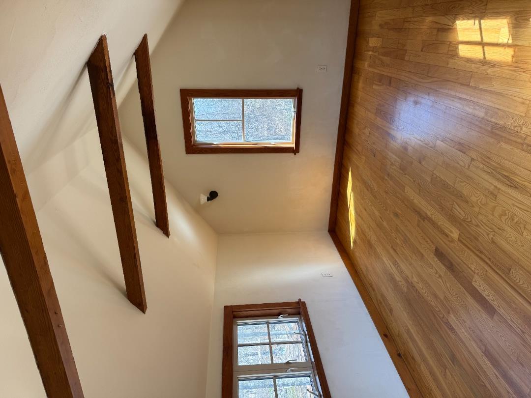 4 Rock Pond Road West Tisbury, MA 02568 - Photo 16 of 37 a view of an empty room with wooden floor and a window