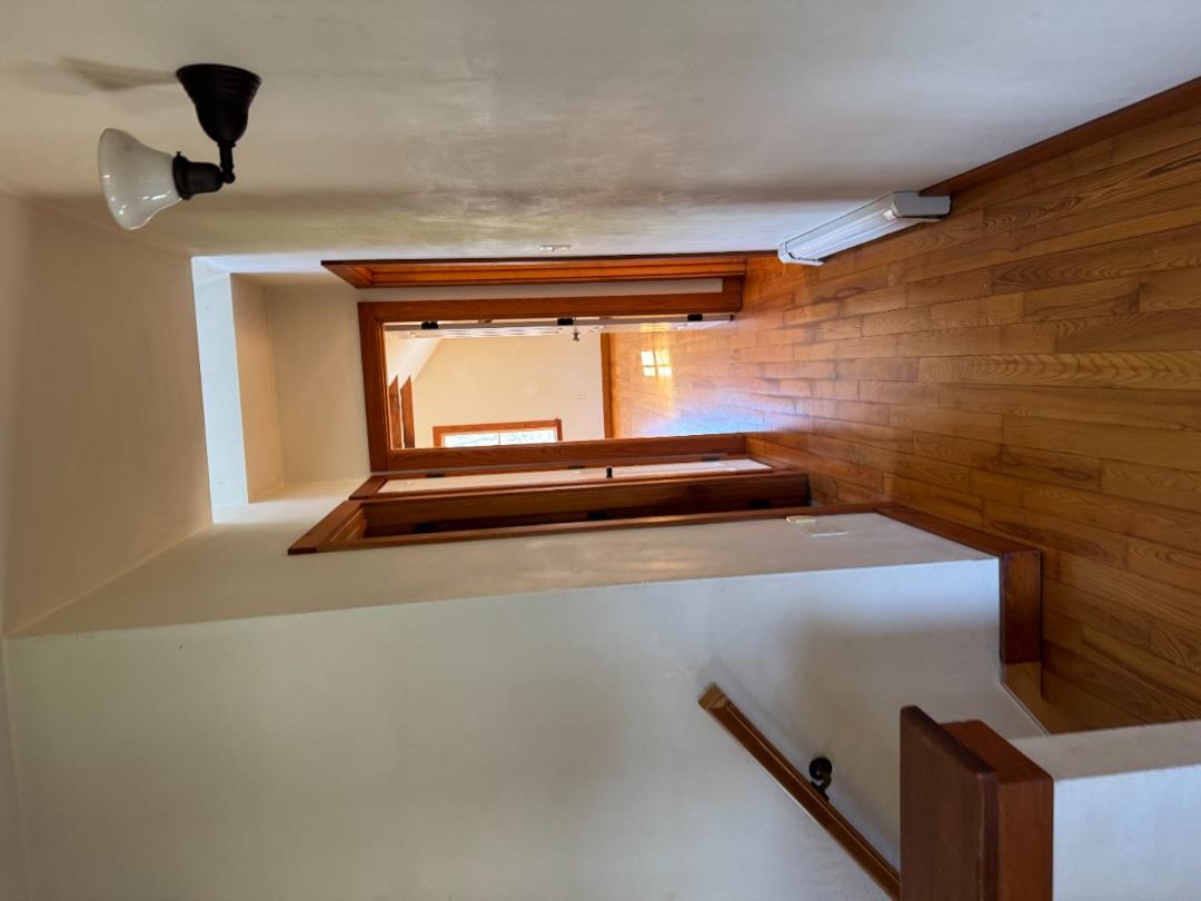 4 Rock Pond Road West Tisbury, MA 02568 - Photo 17 of 37 a hallway with wooden floor table and chairs