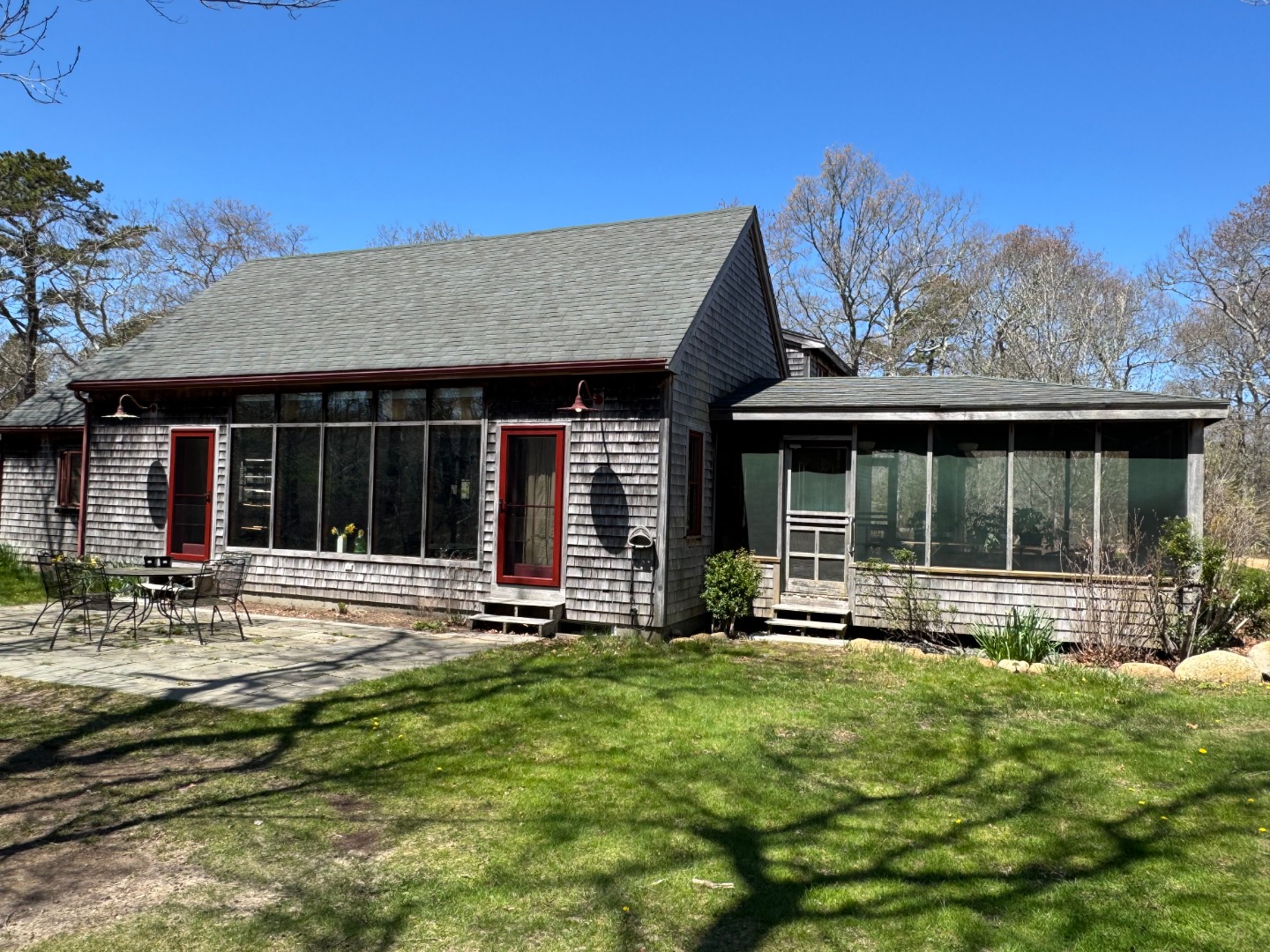 4 Rock Pond Road West Tisbury, MA 02568 - Photo 34 of 37 a front view of a house with a yard table and chairs