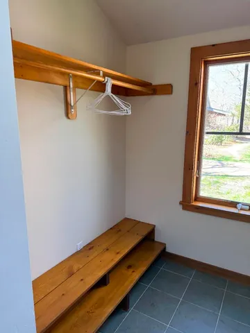 a view of a room with rack on the wall and a window