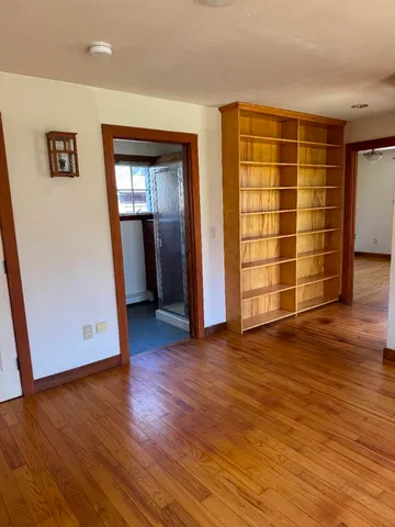 a living room with fireplace furniture and a large window