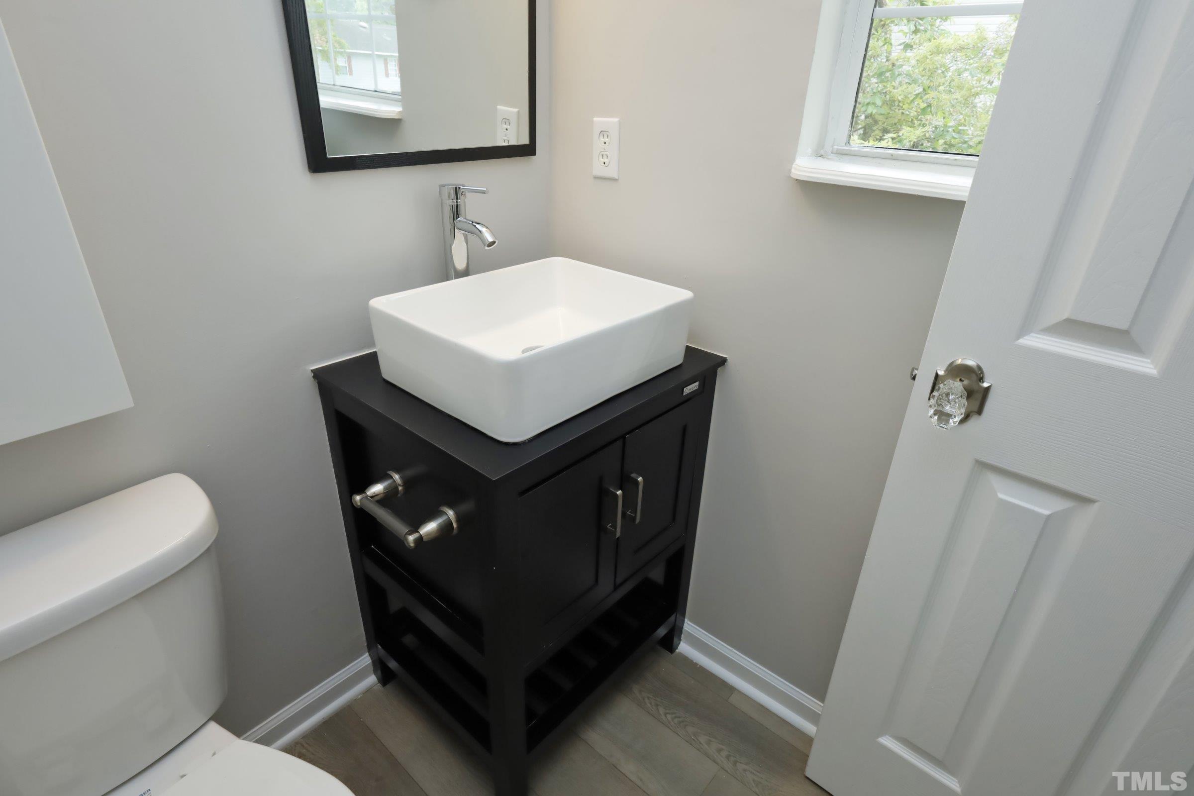 100 Mitchener Street Garner, NC 27529 - Photo 21 of 37 a bathroom with a sink toilet and mirror