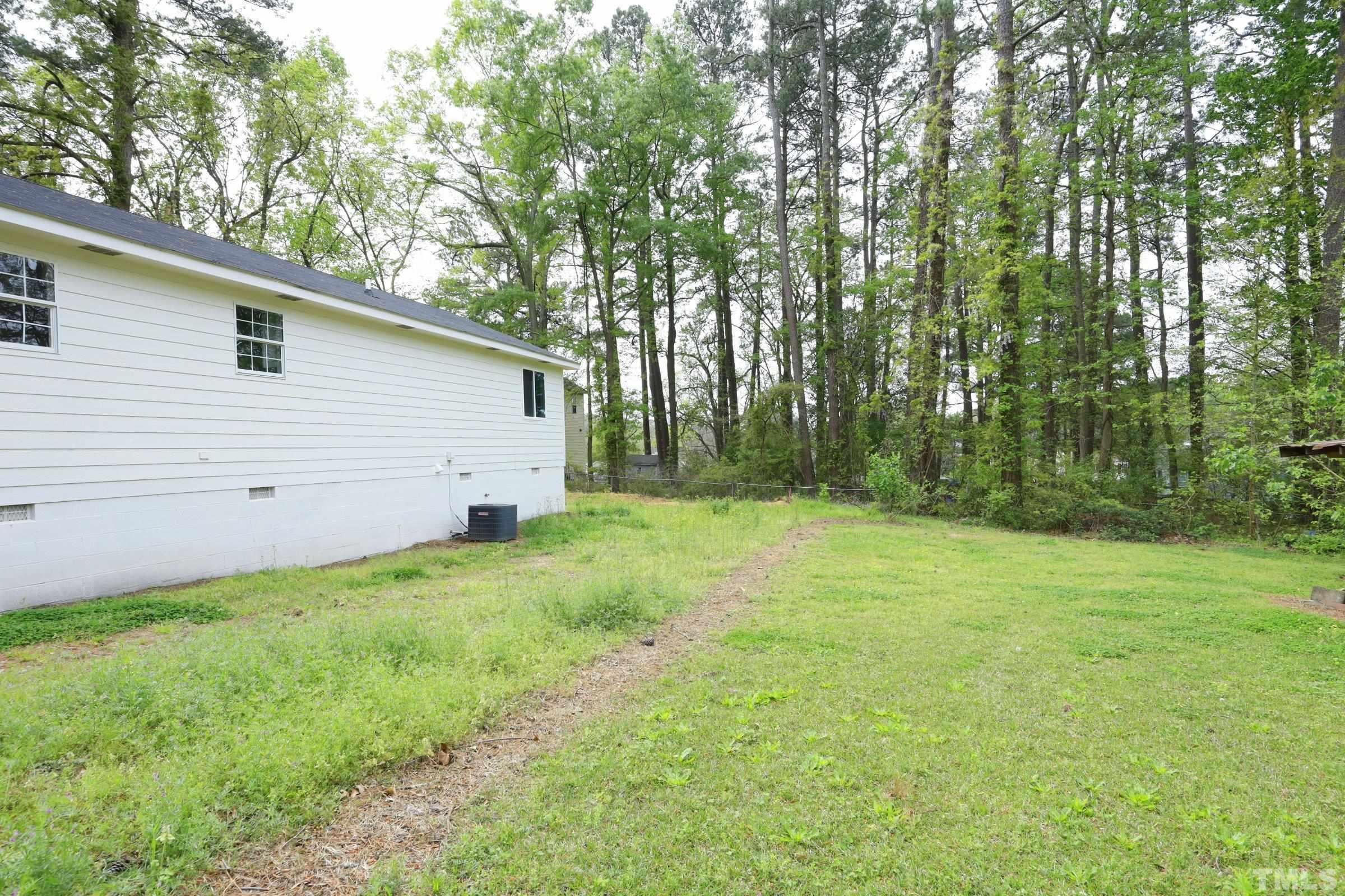 100 Mitchener Street Garner, NC 27529 - Photo 35 of 37 a view of a backyard with a large tree