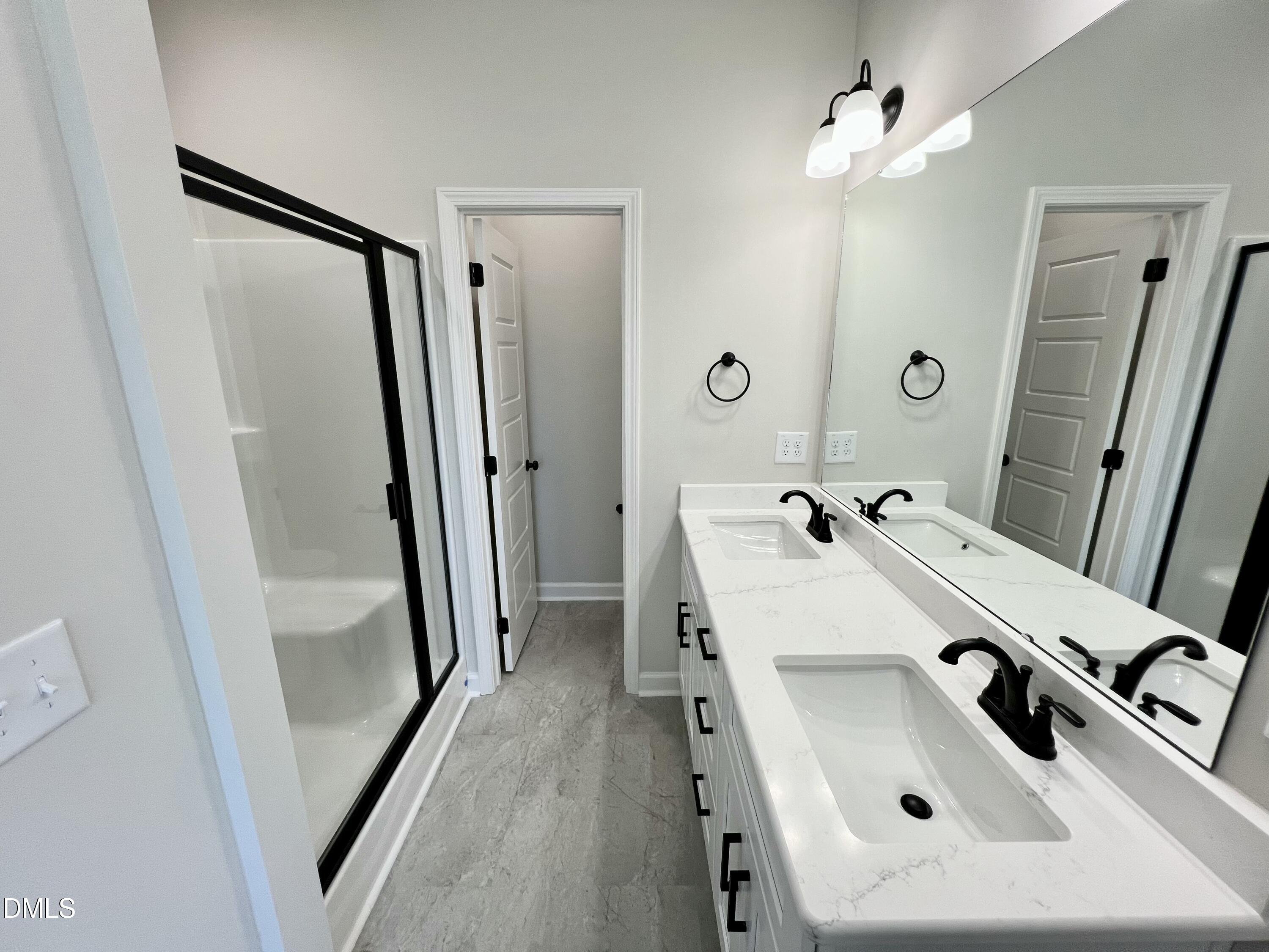 1787 Walnut Run Drive Deep Run, NC 28525 - Photo 11 of 23 a bathroom with a sink a mirror a vanity and a shower