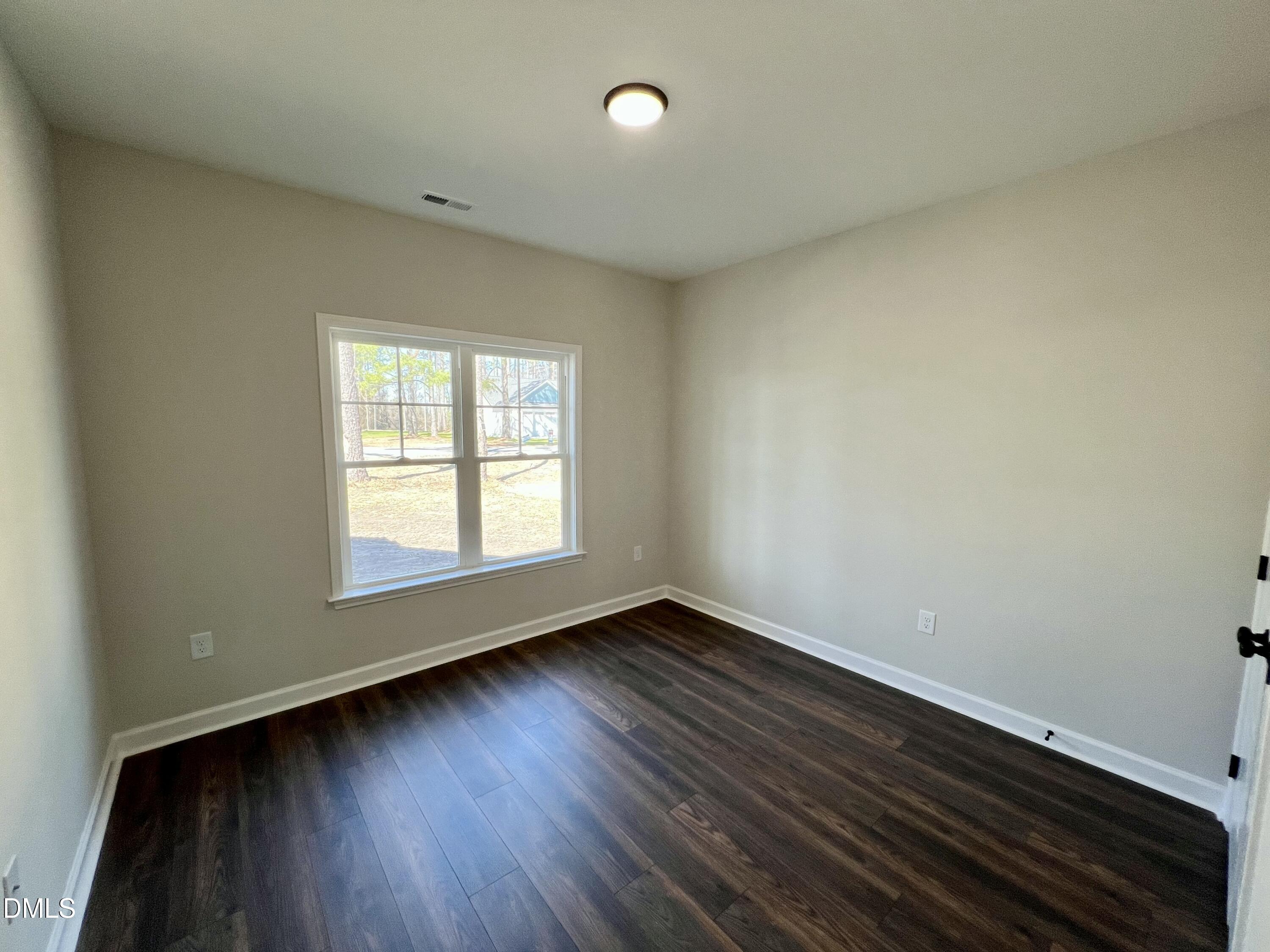 1787 Walnut Run Drive Deep Run, NC 28525 - Photo 14 of 23 an empty room with wooden floor and windows