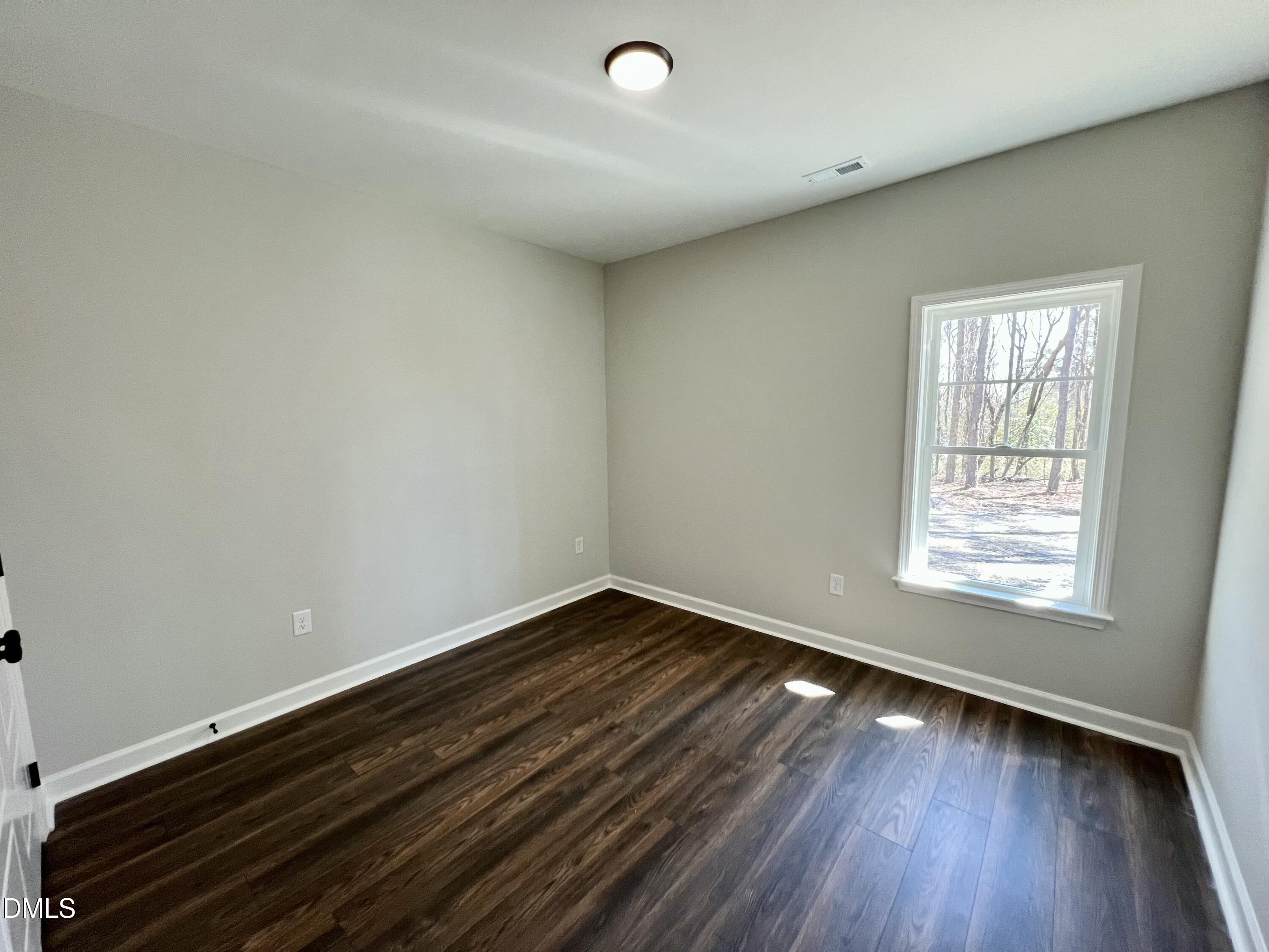 1787 Walnut Run Drive Deep Run, NC 28525 - Photo 16 of 23 an empty room with wooden floor and windows