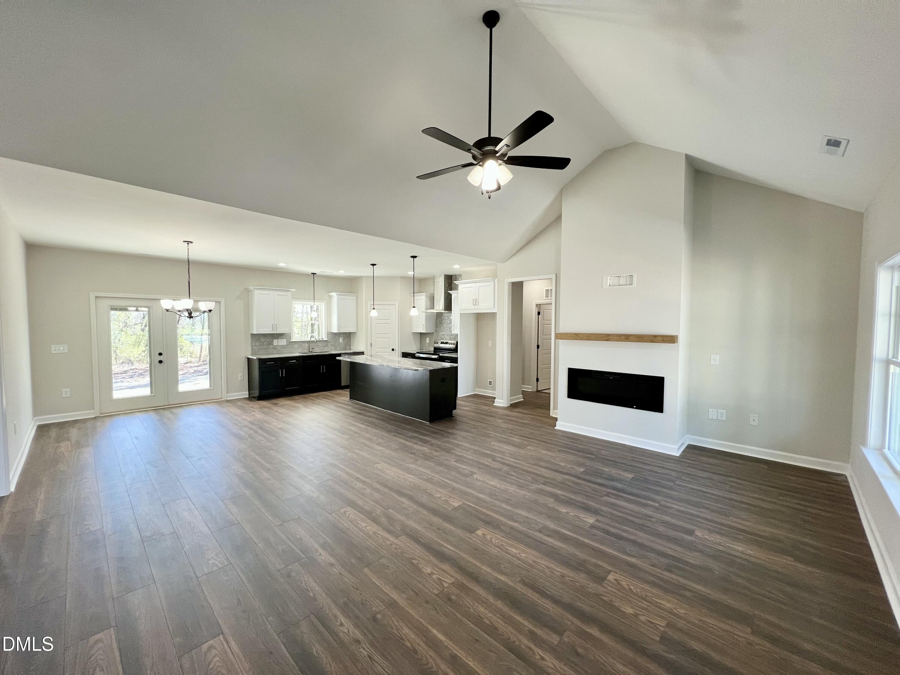 1787 Walnut Run Drive Deep Run, NC 28525 - Photo 3 of 23 a view of empty room with kitchen and fireplace