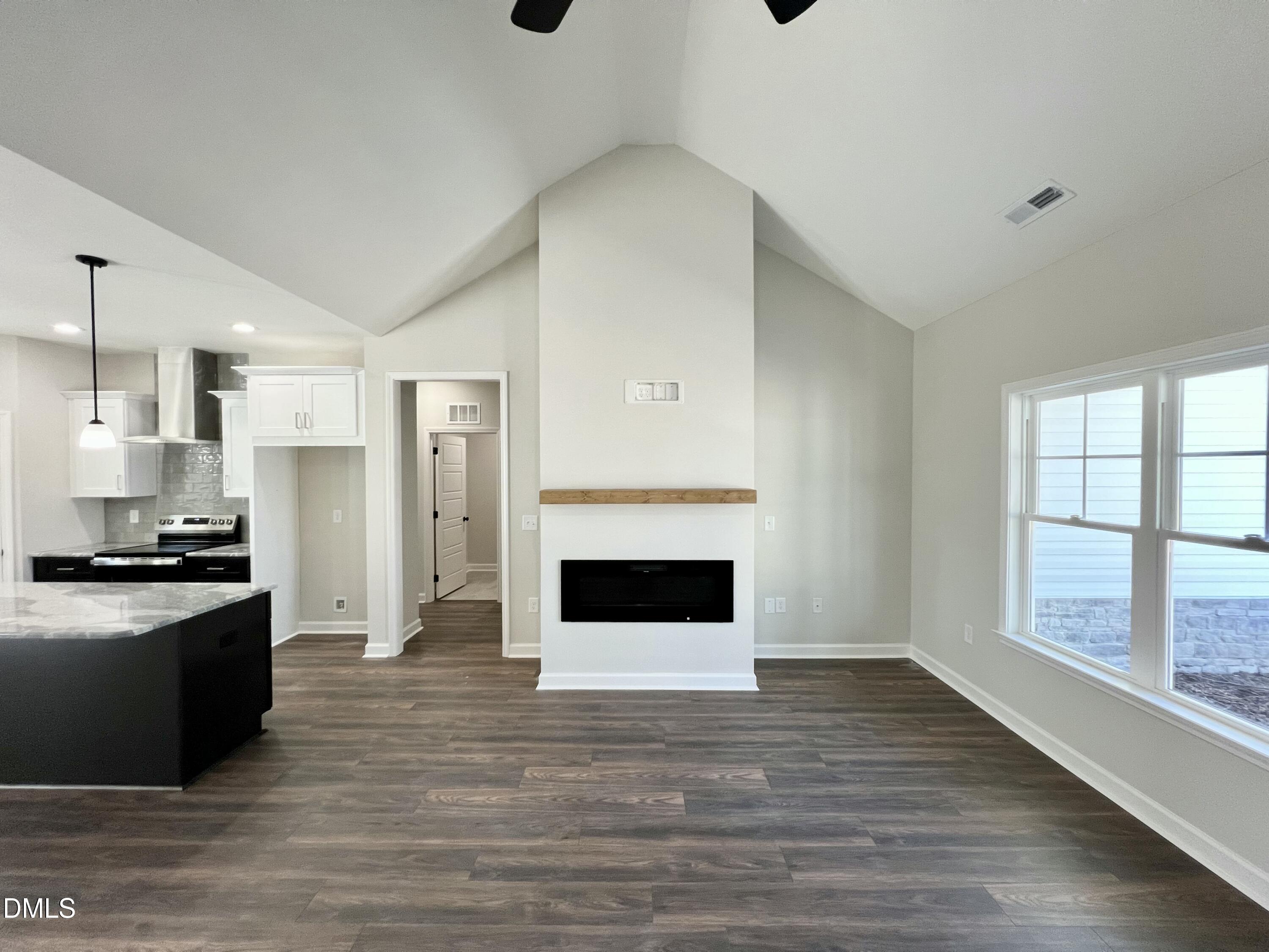 1787 Walnut Run Drive Deep Run, NC 28525 - Photo 4 of 23 a living room with stainless steel appliances kitchen island granite countertop a stove and a refrigerator