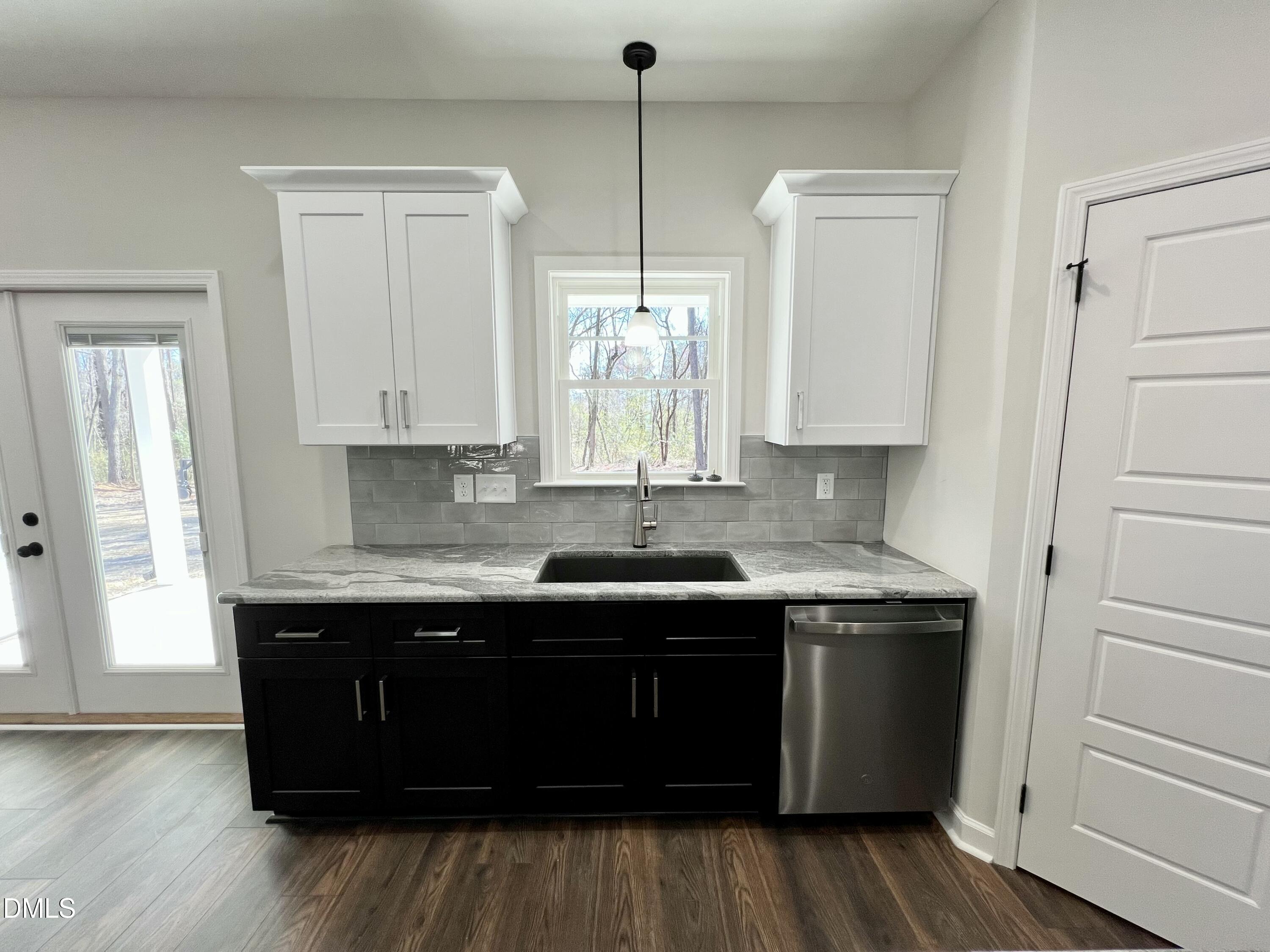 1787 Walnut Run Drive Deep Run, NC 28525 - Photo 7 of 23 a kitchen with stainless steel appliances granite countertop a sink a stove and a wooden floors