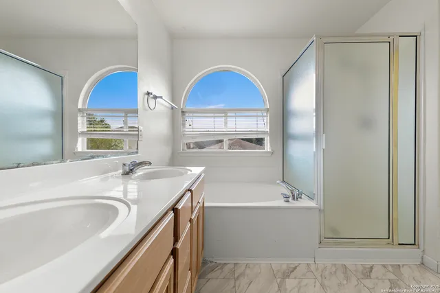 a bathroom with a tub sink and mirror