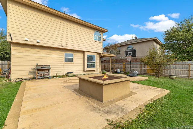 a view of a house with backyard and sitting area