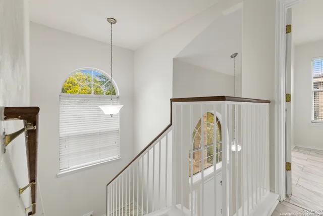 a view of water heater room with wooden floor