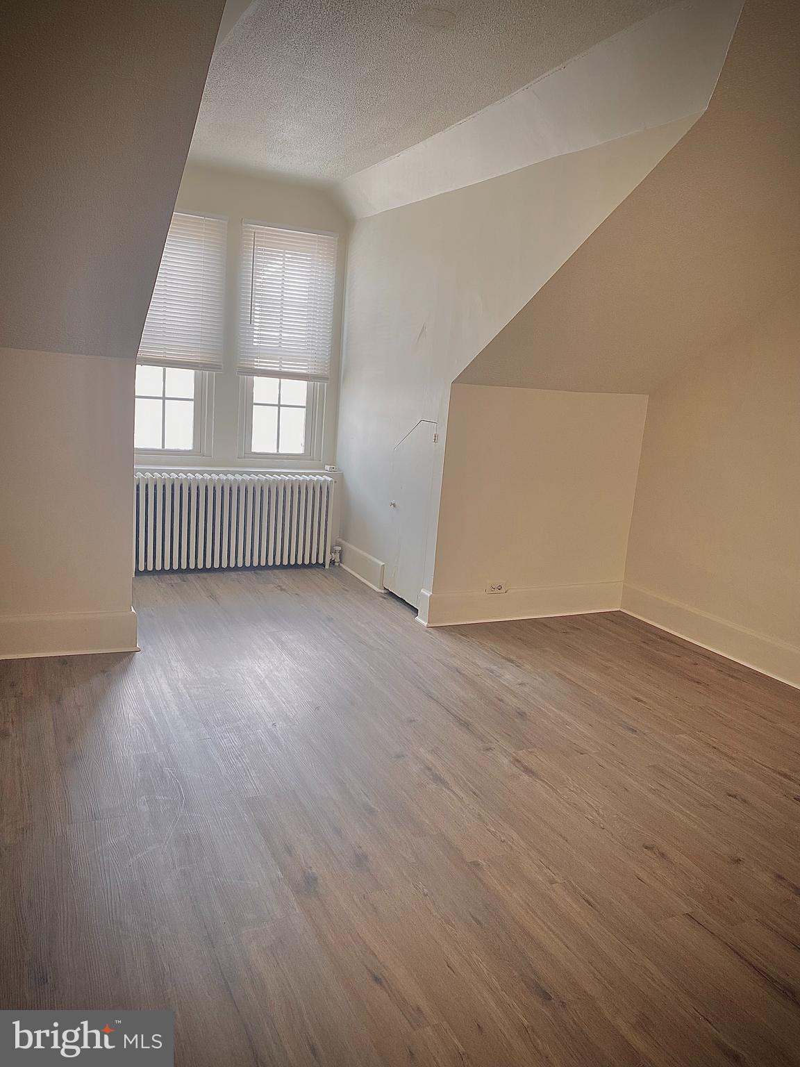424 Locust Street Reading, PA 19604 - Photo 15 of 17 an empty room with wooden floor and windows