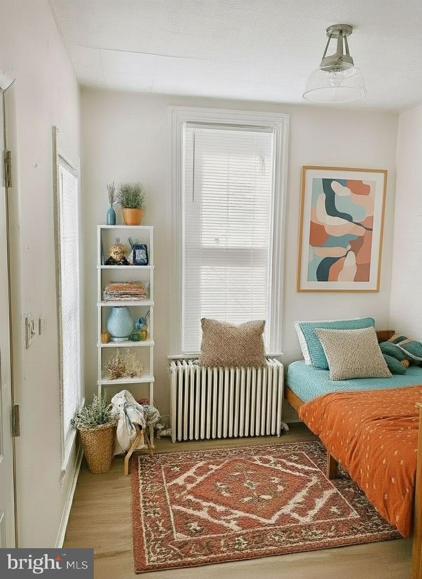 424 Locust Street Reading, PA 19604 - Photo 8 of 17 a bedroom with a bed and wooden floor