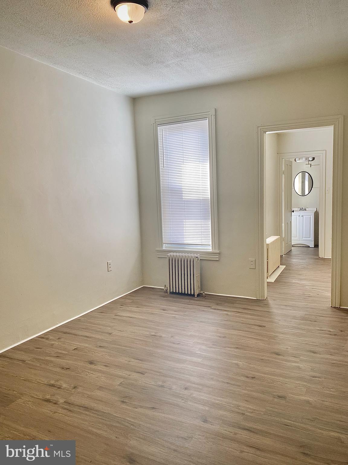 424 Locust Street Reading, PA 19604 - Photo 10 of 17 a view of an empty room with wooden floor and a window
