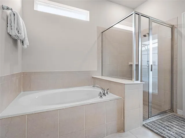 a large bed sitting in a bedroom next to a window