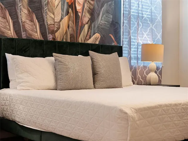 a view of a house with a yard and potted plants