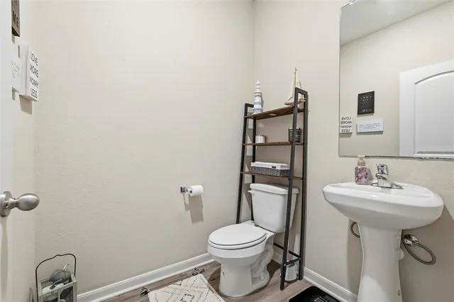 a bathroom with a sink toilet and a mirror