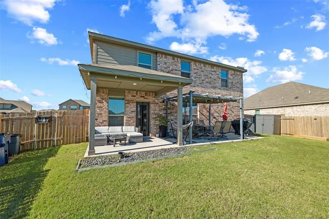 a view of a house with backyard porch and sitting area