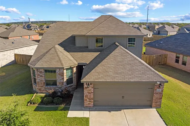 an aerial view of a house with yard porch and furniture