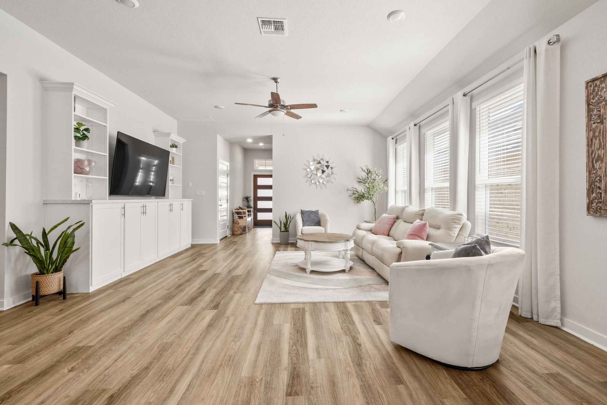 1006 Summer Glen Georgetown, TX 78628 - Photo 13 of 40 A wall of windows pulls in natural light, emphasizing the scale of the living area without compromising privacy