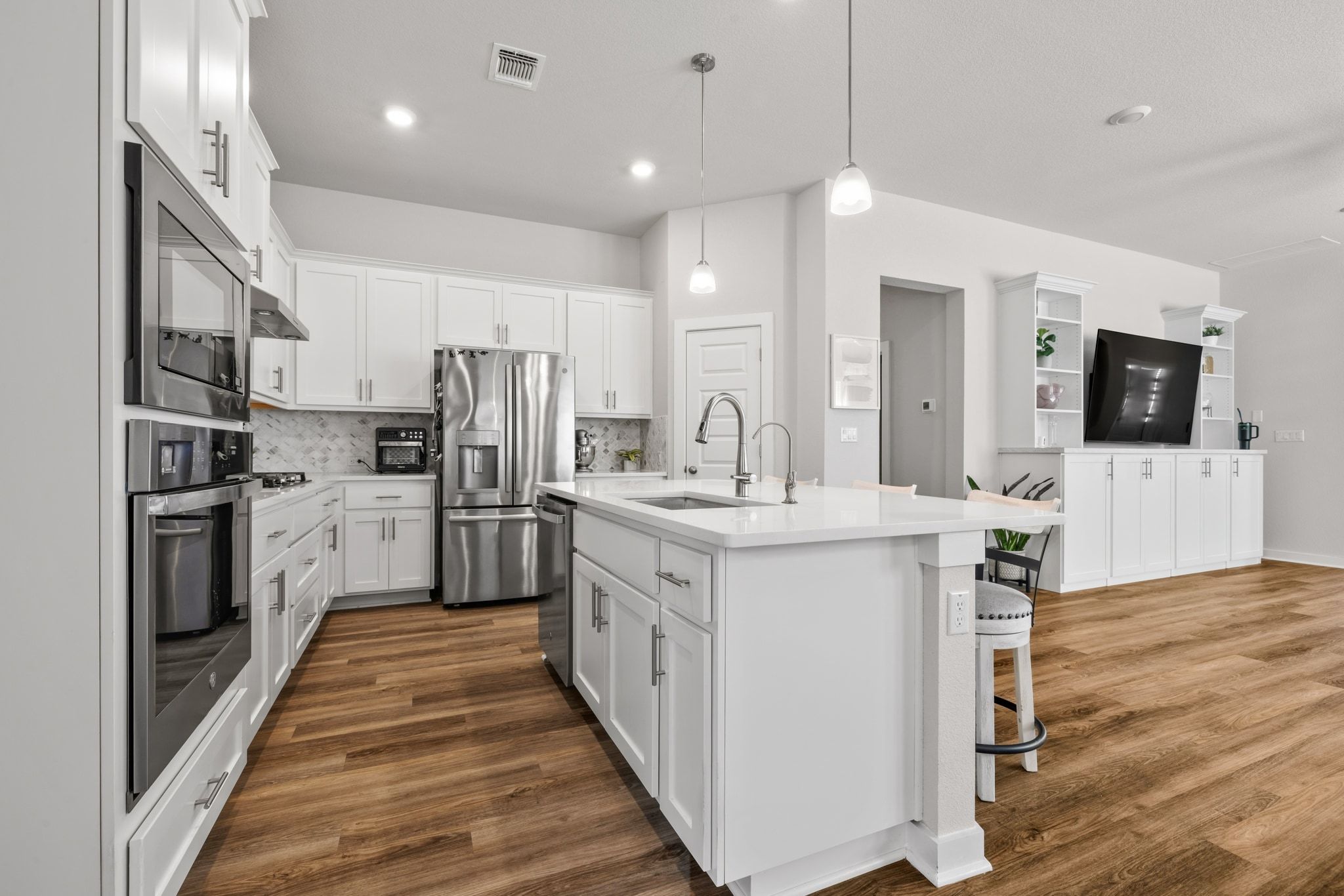 1006 Summer Glen Georgetown, TX 78628 - Photo 18 of 40 Centrally positioned in the home, the kitchen directly connects to both the living and dining areas, providing a layout that remains open to all common spaces